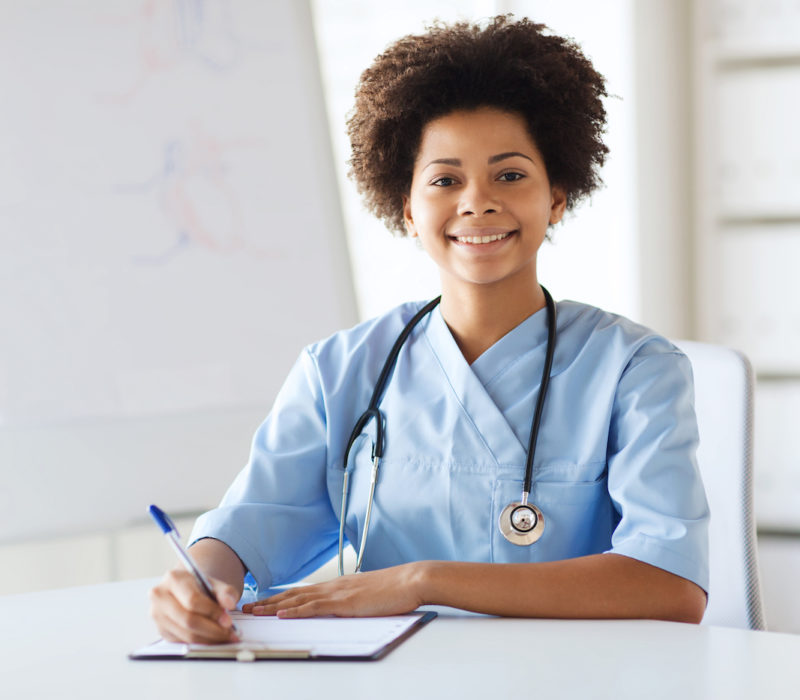 patientforms doctor or nurse writing medical report to clipboard